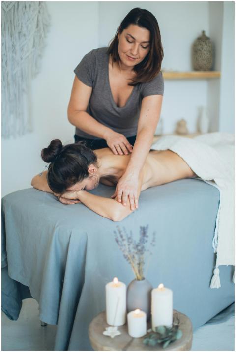 A serene spa setting with a therapist giving a bac
