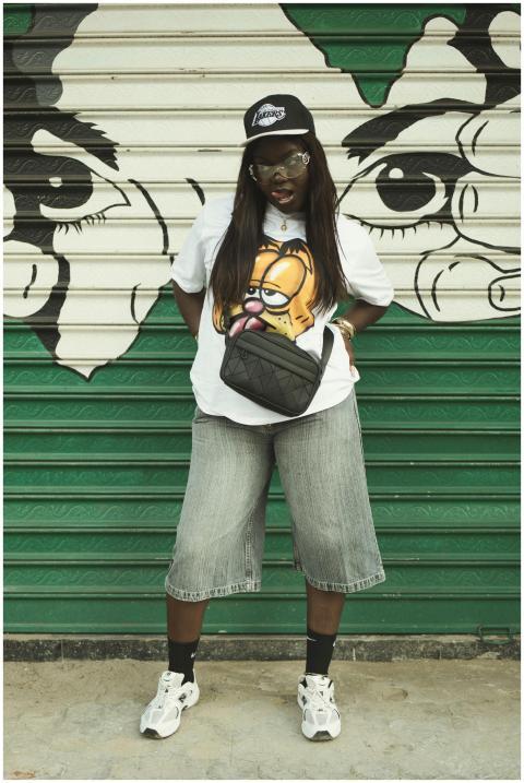 Stylish woman in casual attire standing before a c