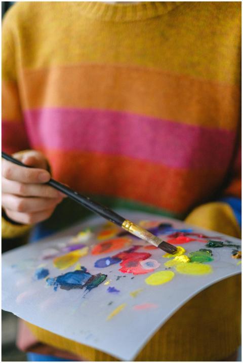 Crop anonymous female artist in casual clothes sta