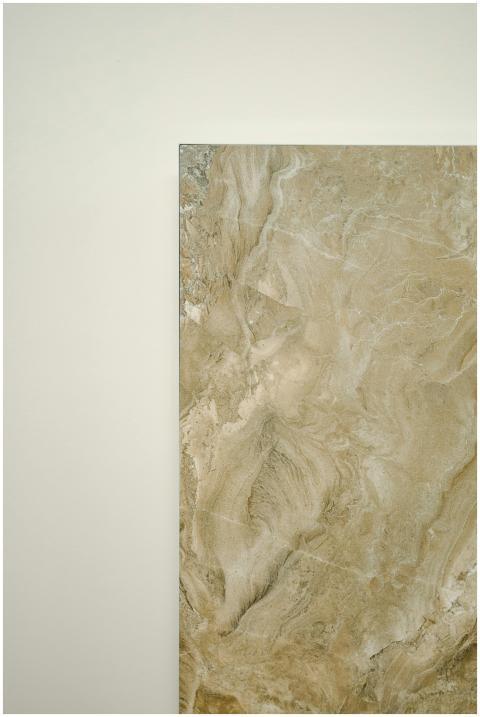 Close-up of a natural stone tile with beige marble