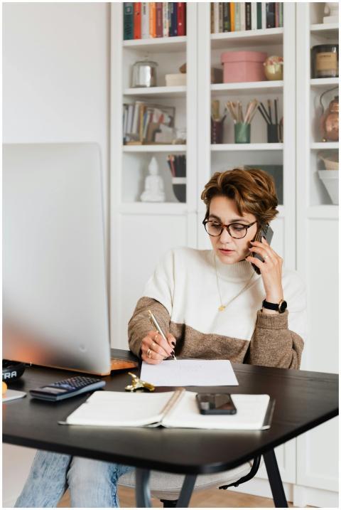 Focused businesswoman in modern office multitaskin