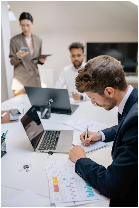 Business professionals collaborating over reports