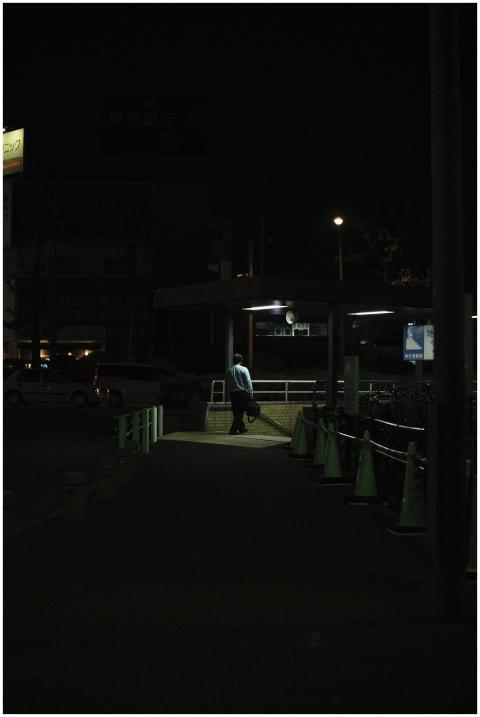 A person walks towards a subway entrance in the ci