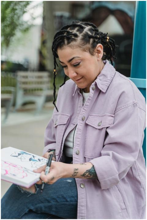 A woman enjoying sketching outdoors, captured in a