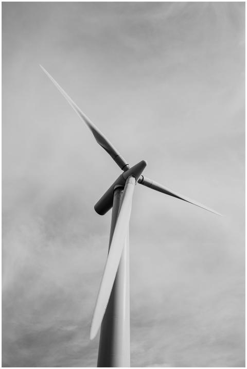 Close-up view of a wind turbine in black and white