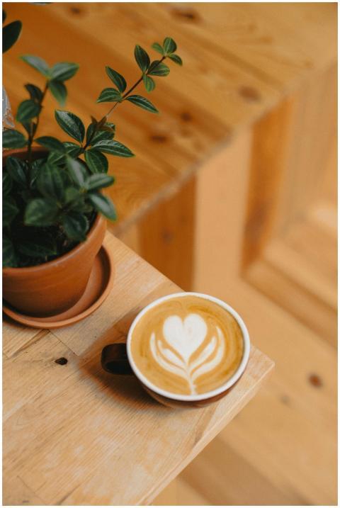 Warm cappuccino with latte art paired with a potte