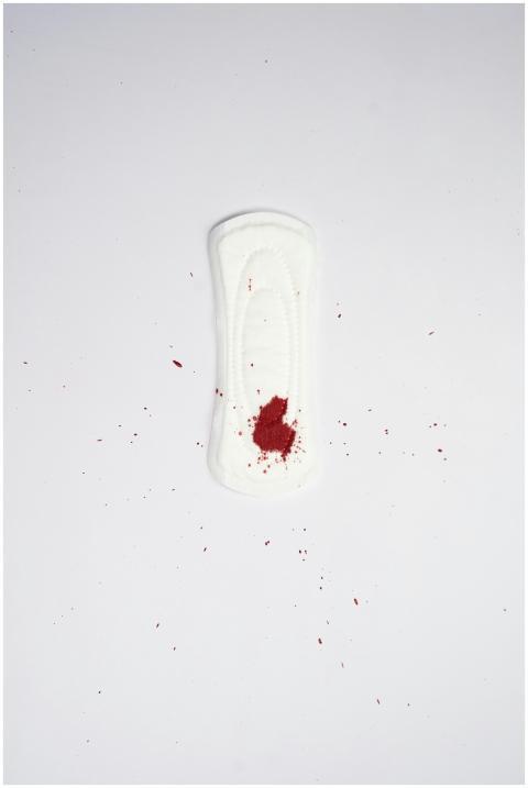 Sanitary pad on white background with blood stain,