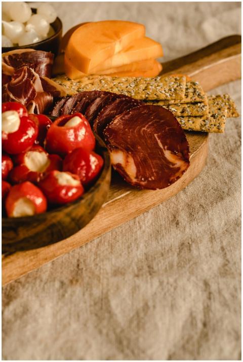 A delicious rustic charcuterie board featuring mea