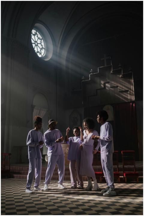 A group of singers performing in an atmospheric ch