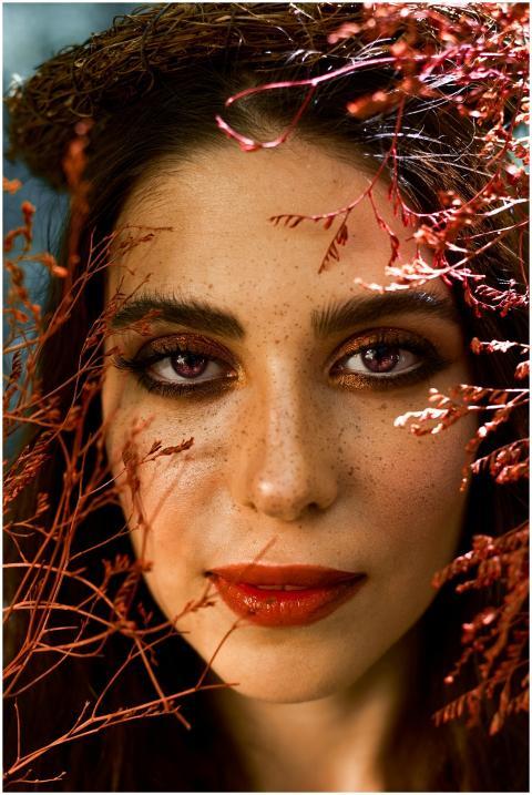 Striking close-up portrait of a woman framed by vi