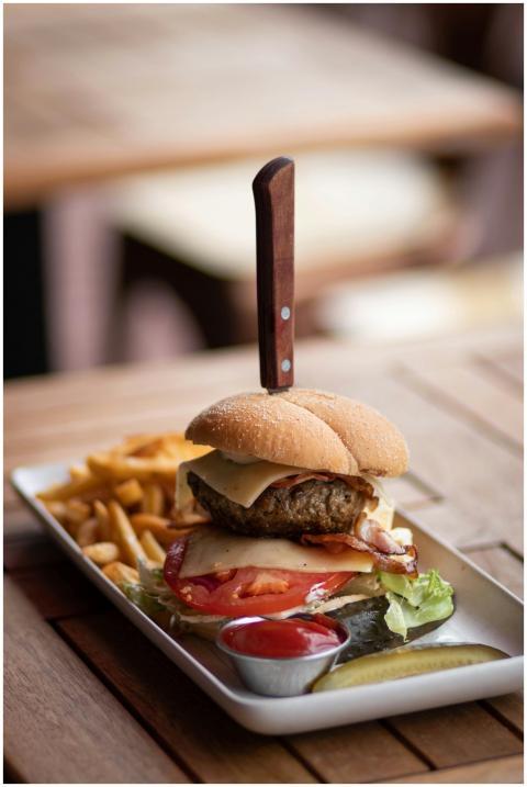 Close-up of a delicious cheeseburger with fries an