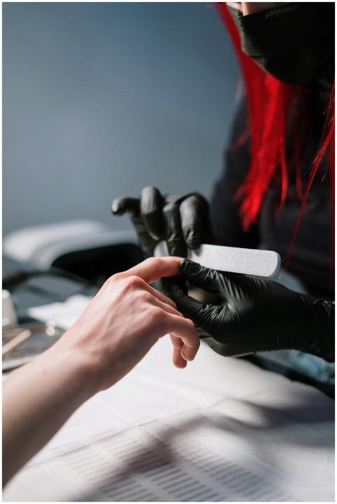 Close-up of a professional manicurist providing na