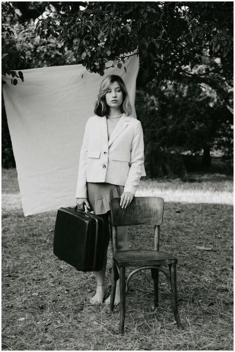 Stylish black and white portrait of a woman holdin