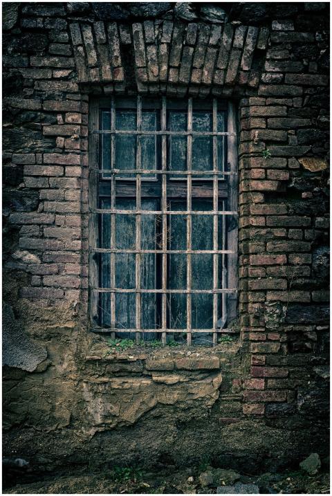 A moody close-up of an old brick wall featuring a