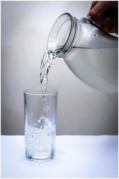 Crystal clear water being poured into a glass from