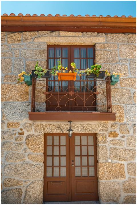 Traditional stone building facade with flowers in
