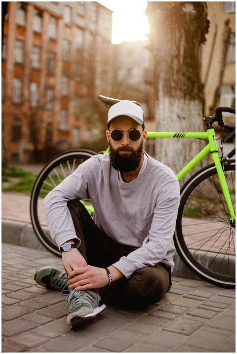 Fashionable man with sunglasses and beard sitting
