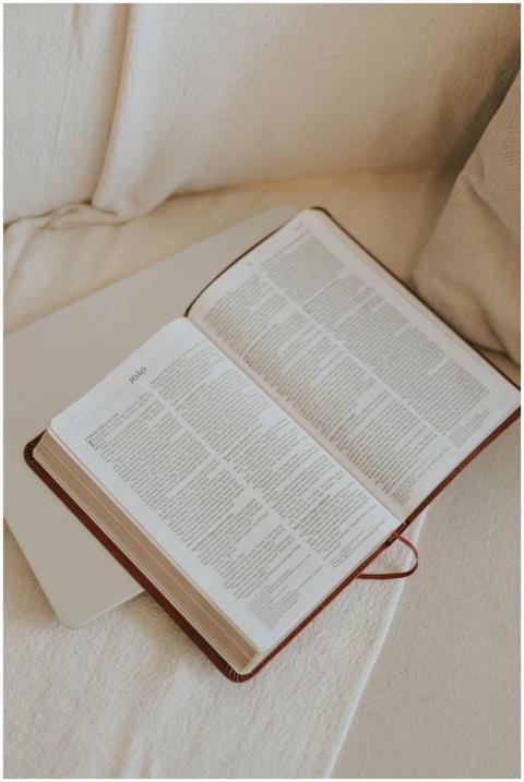 An open Bible resting on a cozy couch, ideal for s