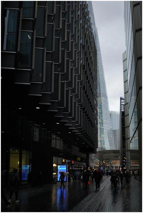 Crowded urban street view featuring The Shard in L
