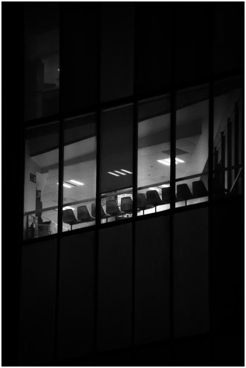A black and white view inside a dark office buildi
