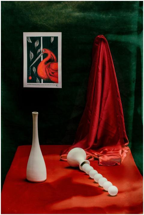 A vibrant still life with red fabric, white cerami