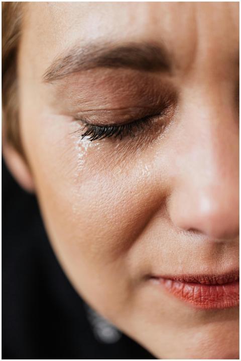 Closeup of crop sad adult lady with natural makeup