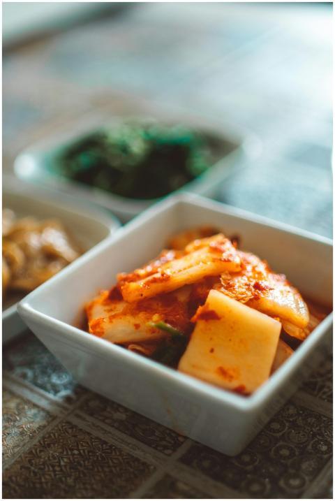 Close-up of spicy Korean kimchi in a ceramic bowl,