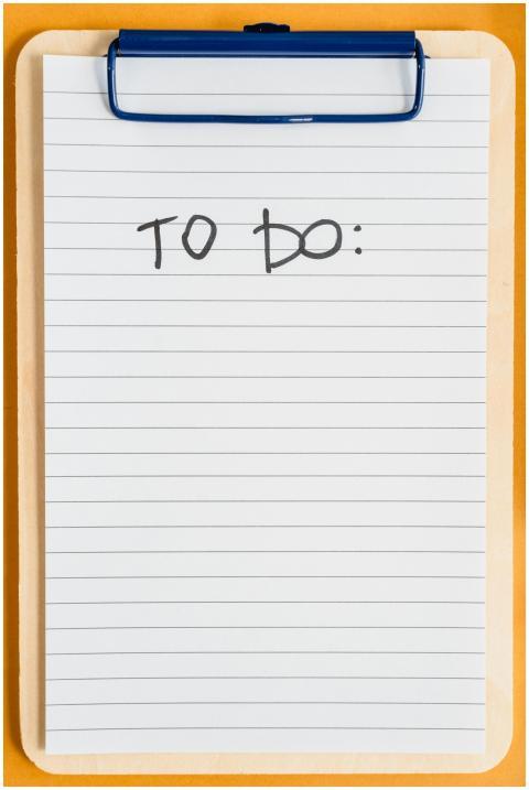 A vertical clipboard with a blank to-do list on li