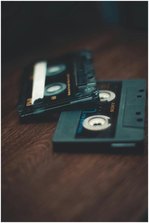 Close-up of retro cassette tapes on a wooden table