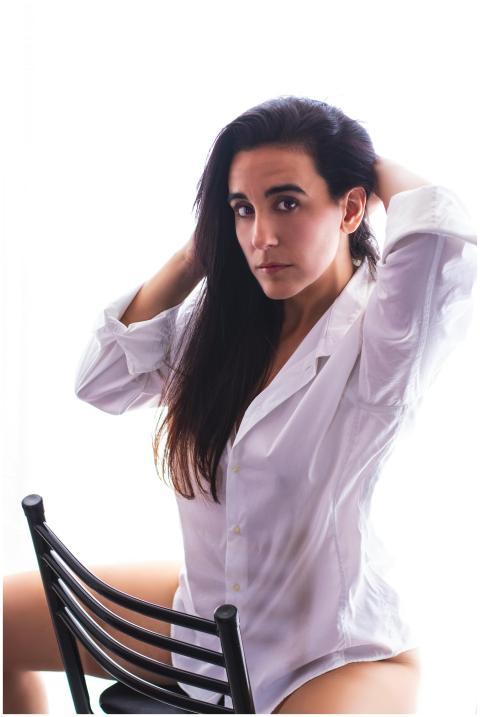 Stylish portrait of a young woman sitting on a cha