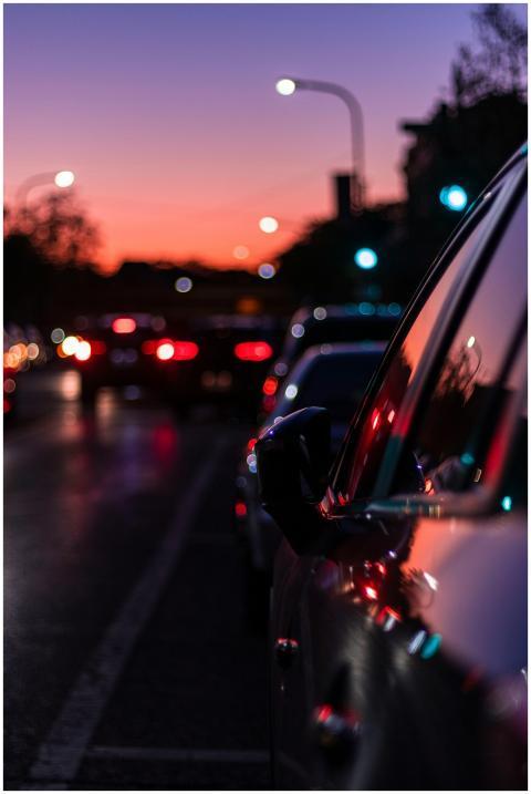 Blurred city street scene at dusk with vibrant lig