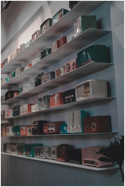 Assorted vintage radios neatly arranged on indoor