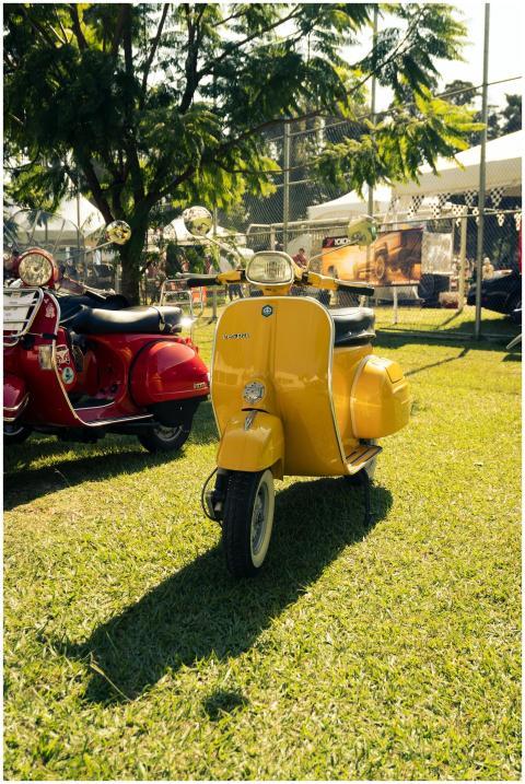 Bright vintage scooters showcased at an outdoor ev