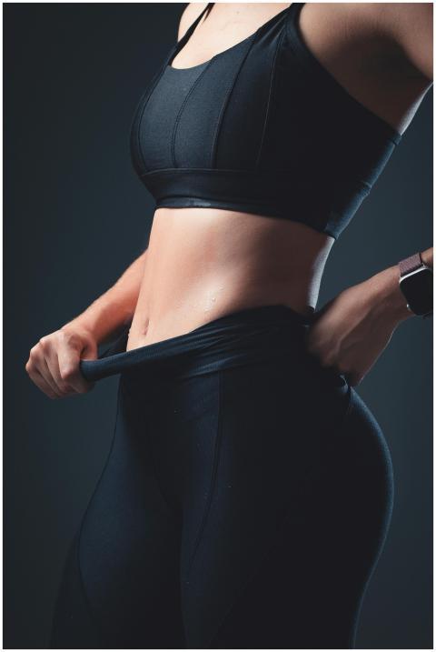 Close-up of a fit woman in sportswear showcasing a