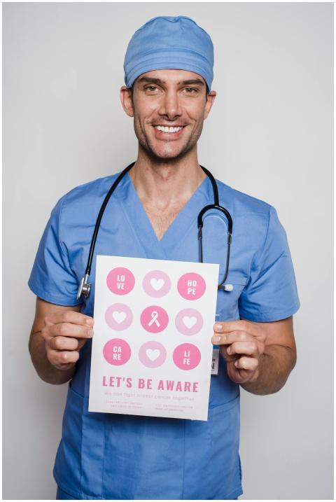 Smiling doctor in blue scrubs holding a breast can