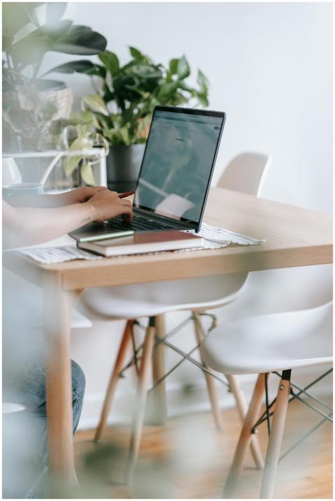 A home office featuring a laptop on a wooden table