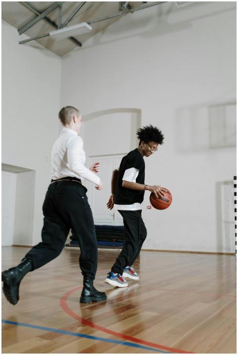 Two young men engaging in a friendly basketball ga