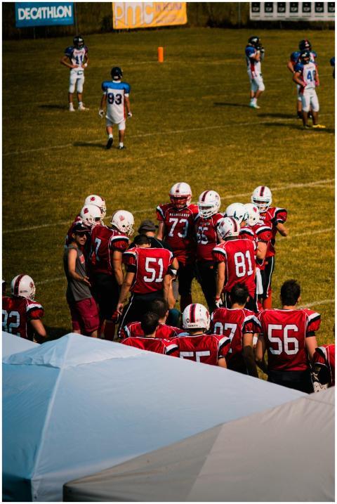 Group of American football players strategizing on
