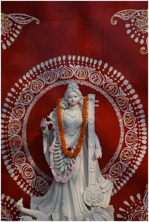 Elegant statue of Hindu goddess Saraswati garlande