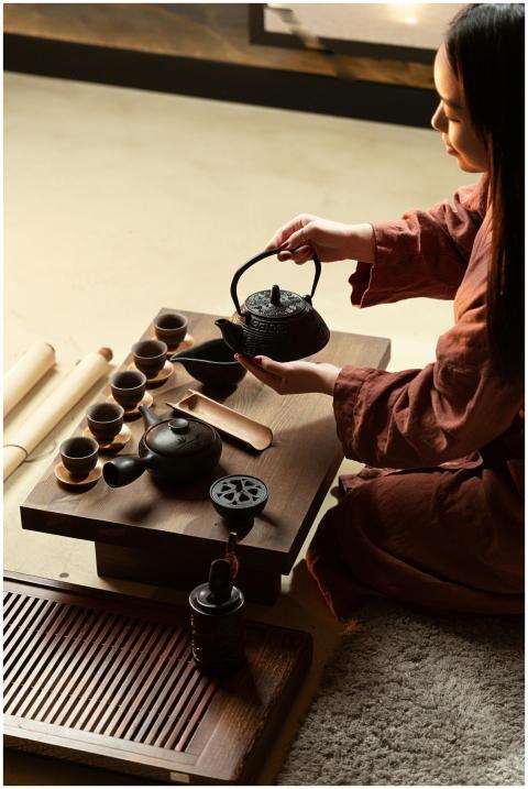 Asian woman performing a traditional tea ceremony