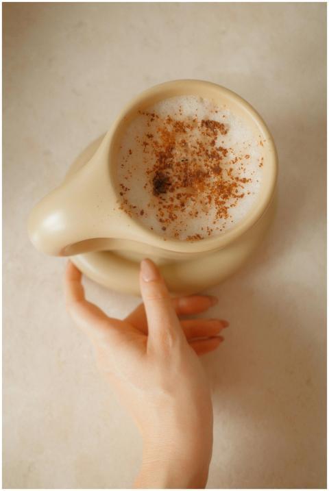 A close-up vertical shot of a cappuccino with cinn