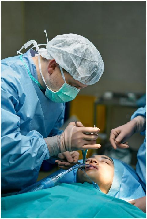 A medical team performs surgery in an operating ro