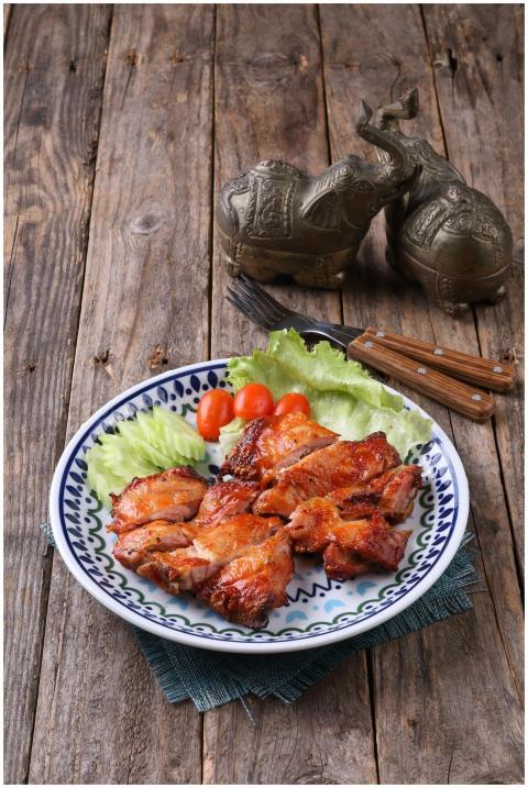 Plate of grilled chicken with lettuce and cherry t