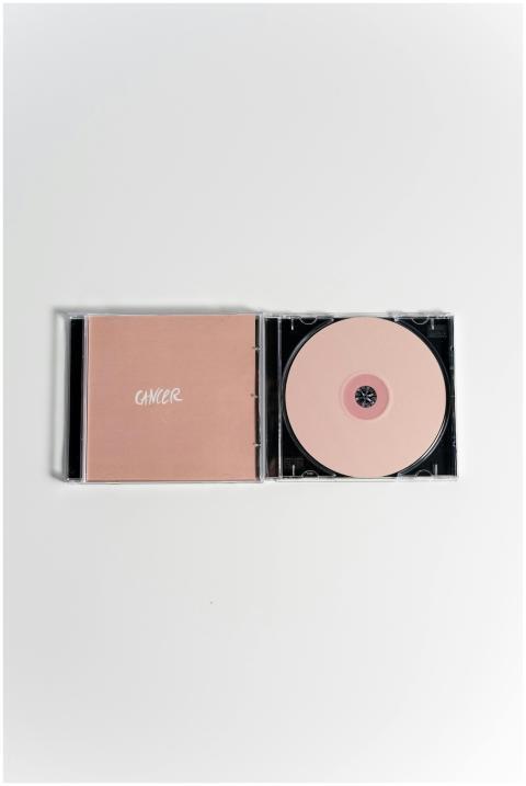 Minimalist pink CD and case representing breast ca