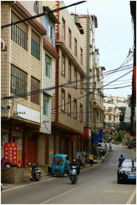 Busy urban street scene with vehicles and pedestri