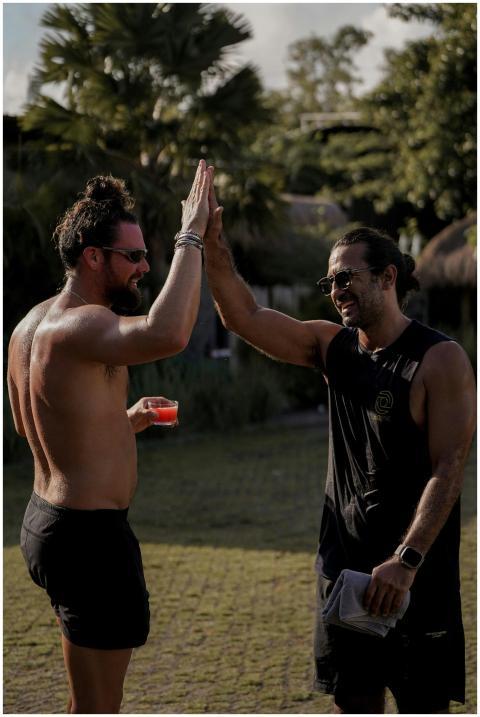 Two men engage in a high five celebrating after a