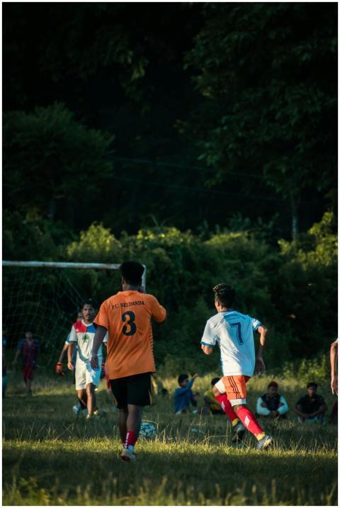 Players competing in a lively soccer game on an ou
