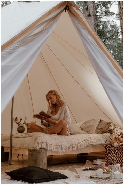 A woman relaxes while reading inside a comfortable