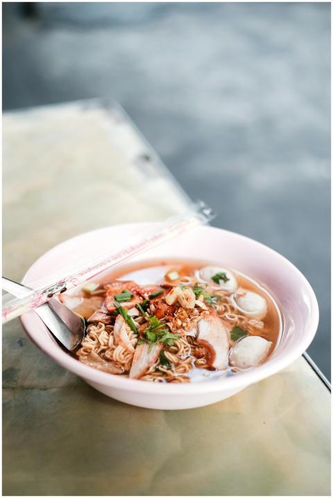 Delicious Thai noodle soup served in a pink bowl w
