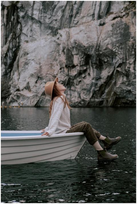 A woman enjoying a peaceful moment on a wooden boa